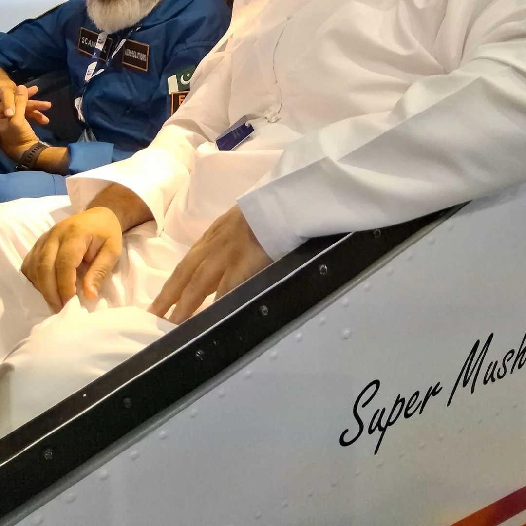 A guest seated in the AeroMix simulator cockpit at Dubai Airshow 2025