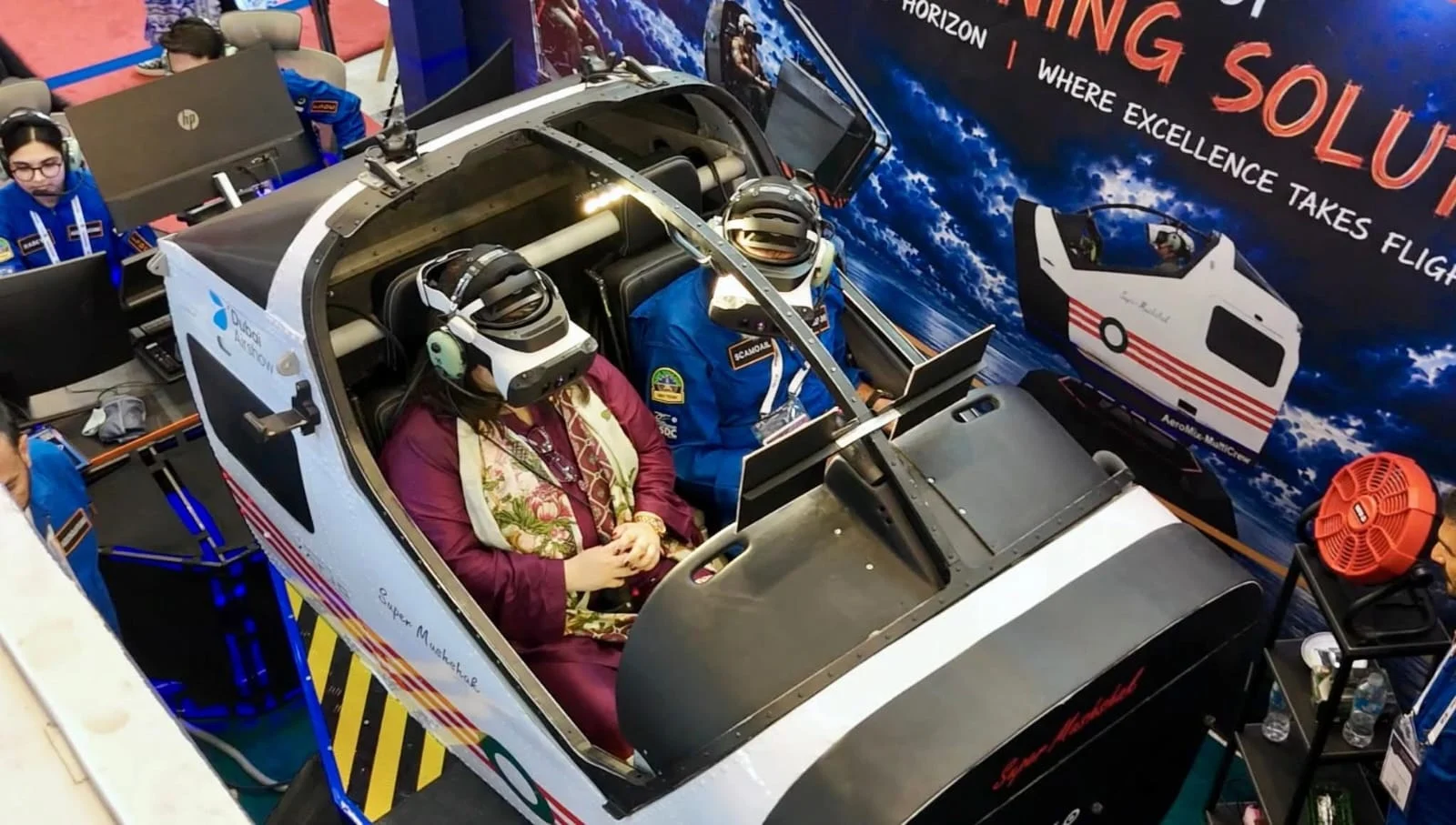 Federal Minister for IT and Telecommunication Shaza Khawaja flying the Super Mushshak simulator in a mixed-reality headset