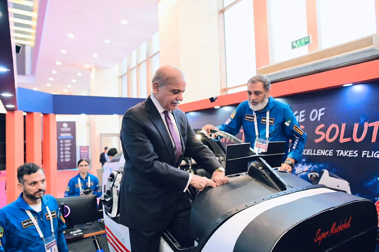 Pakistan's Prime Minister inspecting the Super Mushshak simulator shell with an FSDC engineer explaining the build