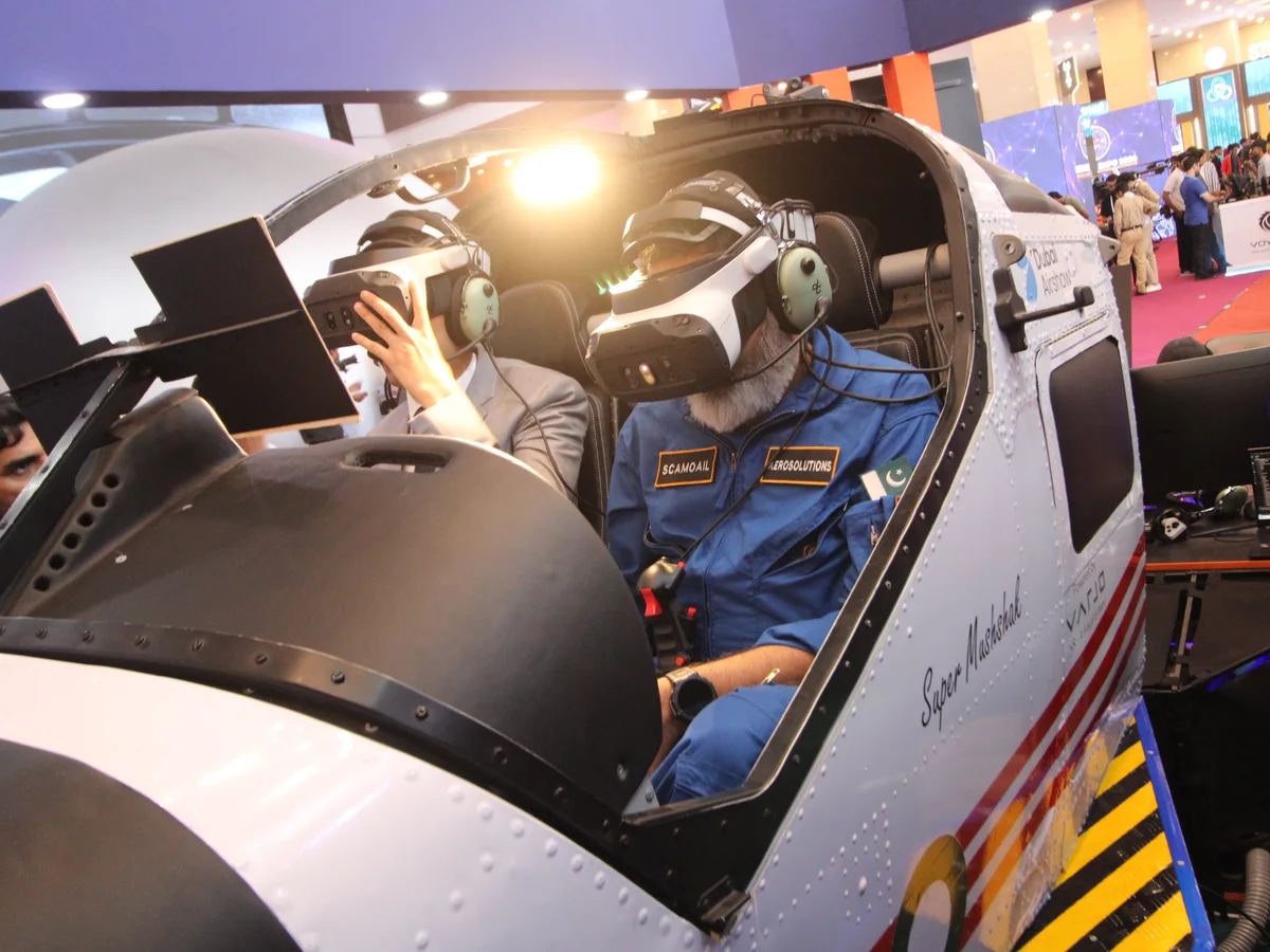 An engineer preparing the simulator cockpit before a session