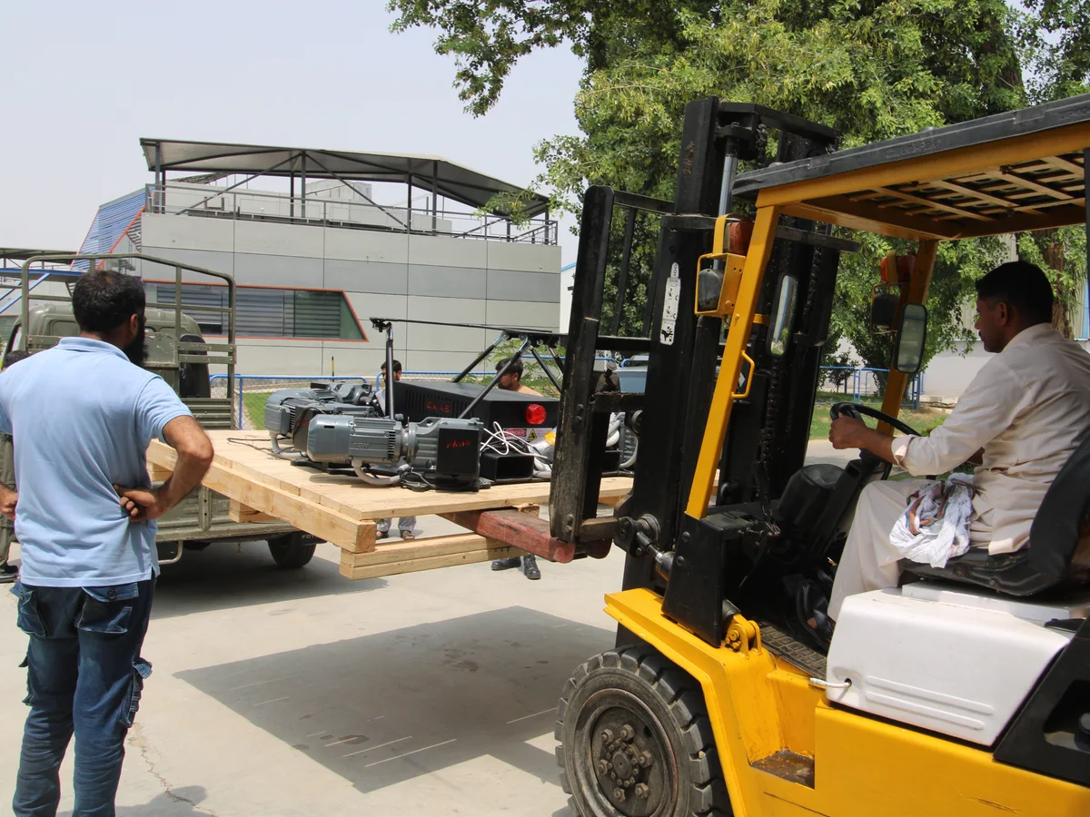 A simulator crated and lifted for shipping