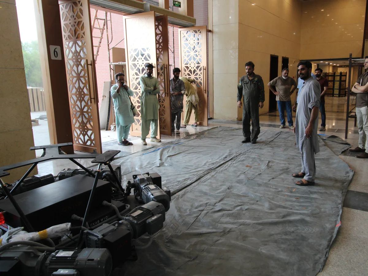Engineers measuring and marking out the installation footprint